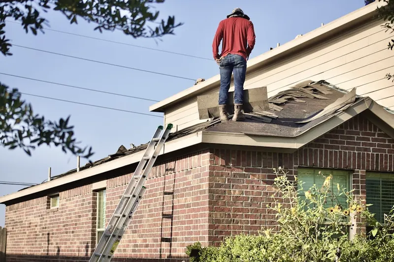 Professional roofer working on a residential roof in Flora Heights